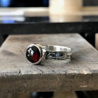 bezel setting with cabochon  cut gemstone