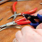 close up of crimping a bead