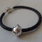 silver bead on plaited leather bead carrier