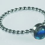 a beaded stacking ring, with bezel and cabochon gemstones set