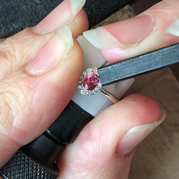 Step 2 - start pressing the prongs against the gemstone using a pusher