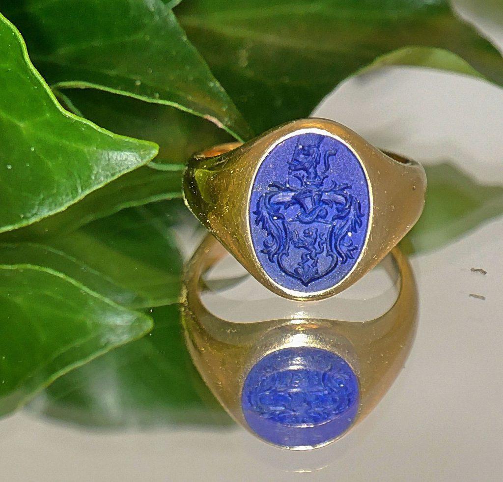 A signet ring with a blue coat of arms. 