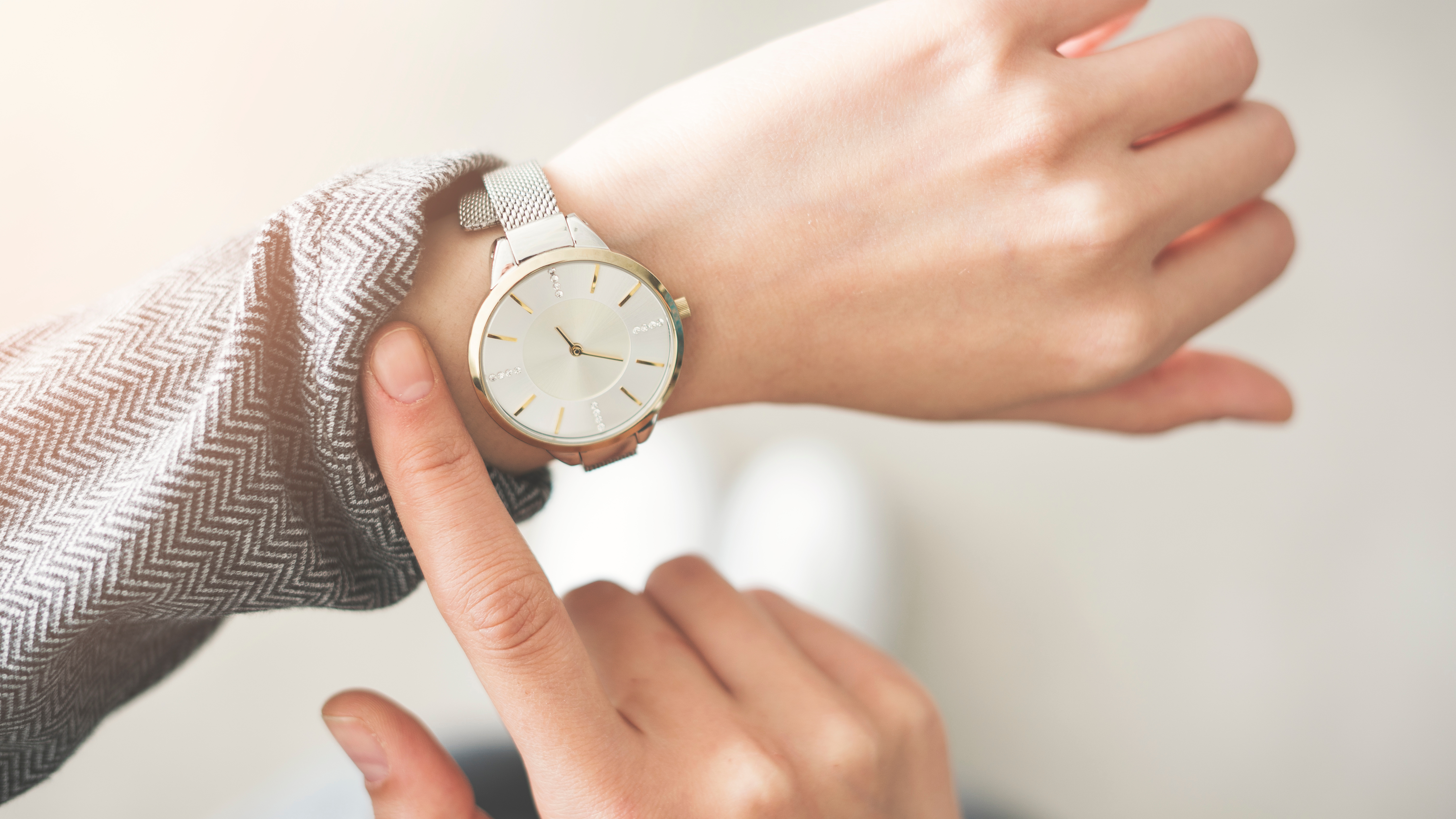 Someone's wrist showing as they check their watch.