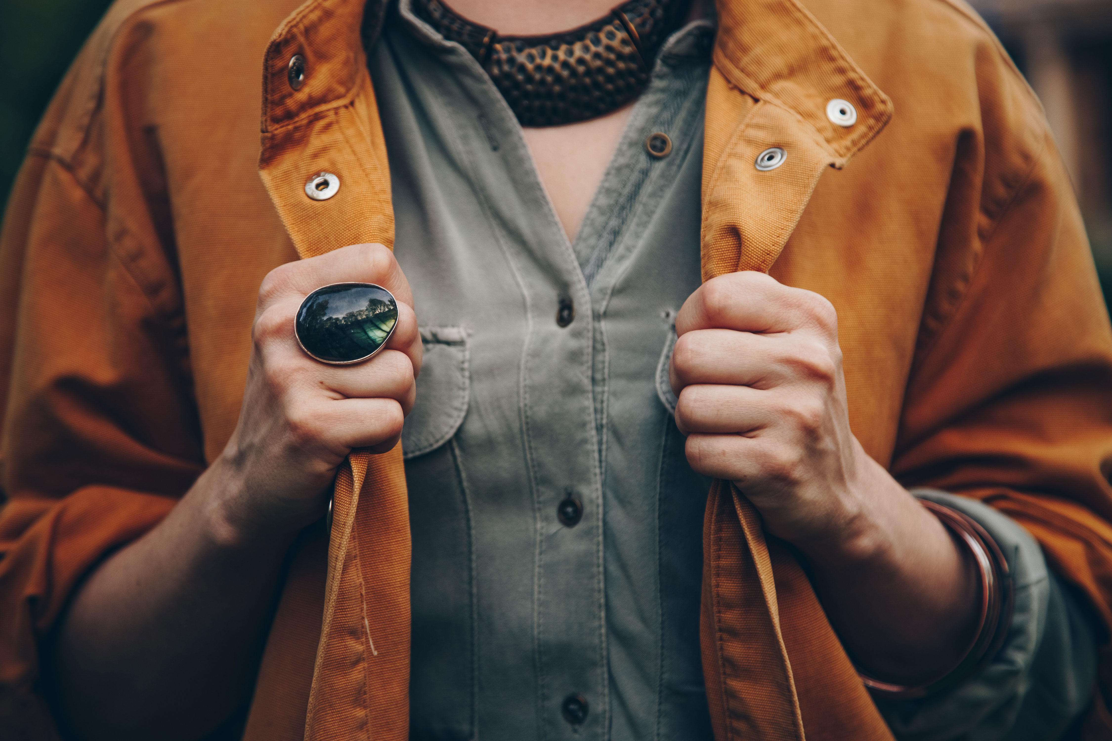 An example of autumn 2023 jewellery trends is shown with a chunky ring on someone's hand.