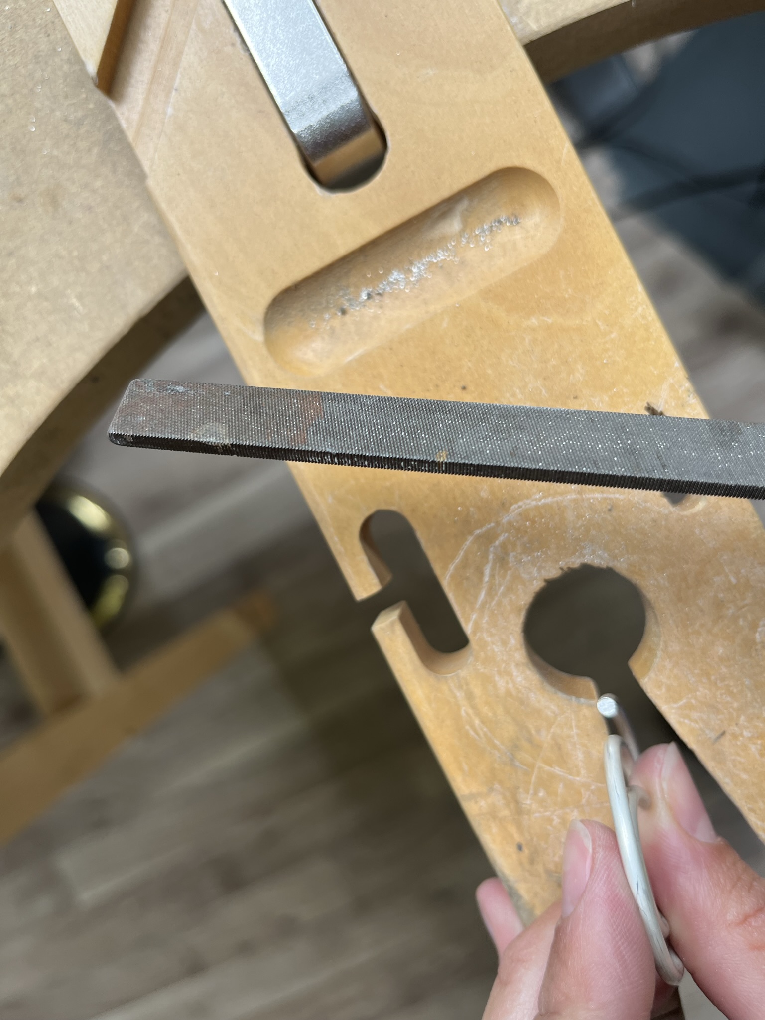 Smooth end of wire using a file