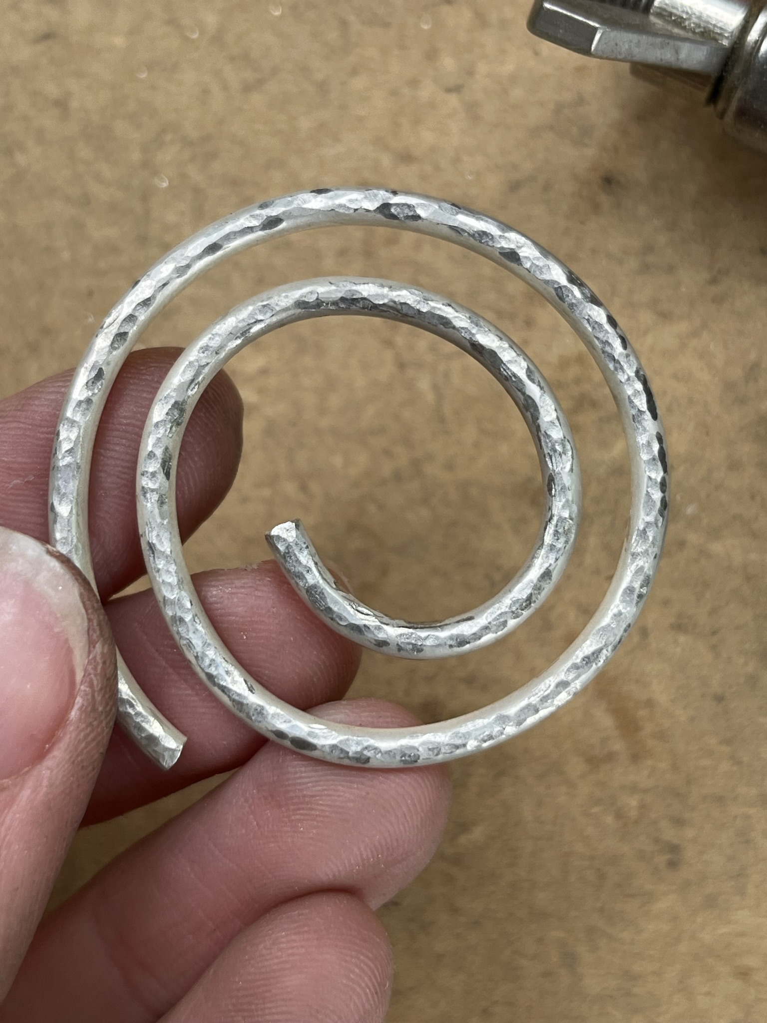 Showing off textured silver pendant