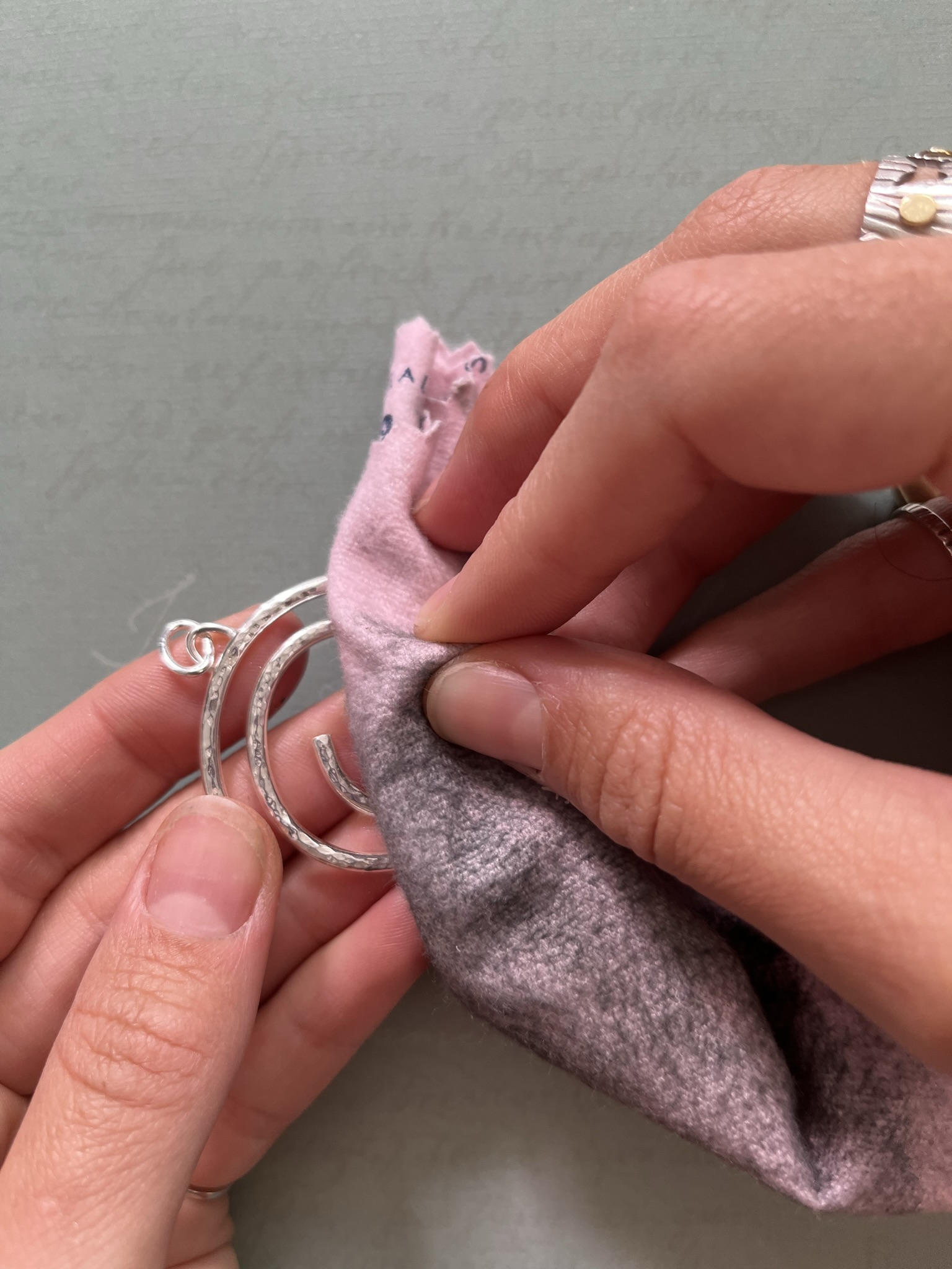 Clean silver pendant with a cleaning cloth