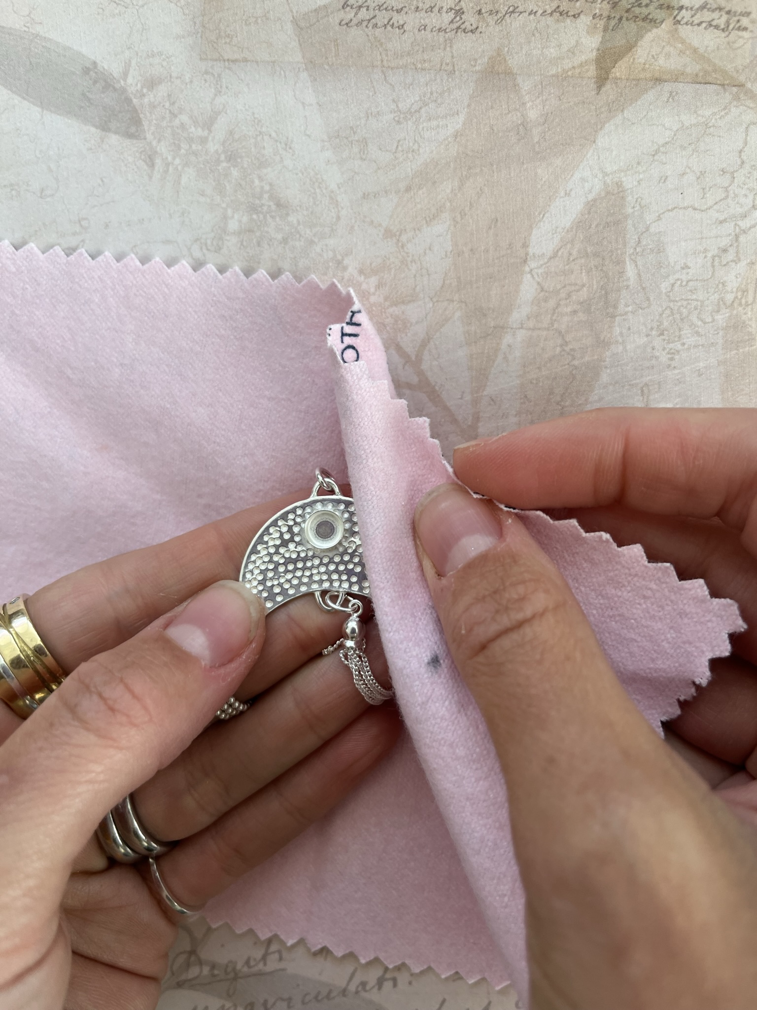 Polish silver pendant using a polishing cloth