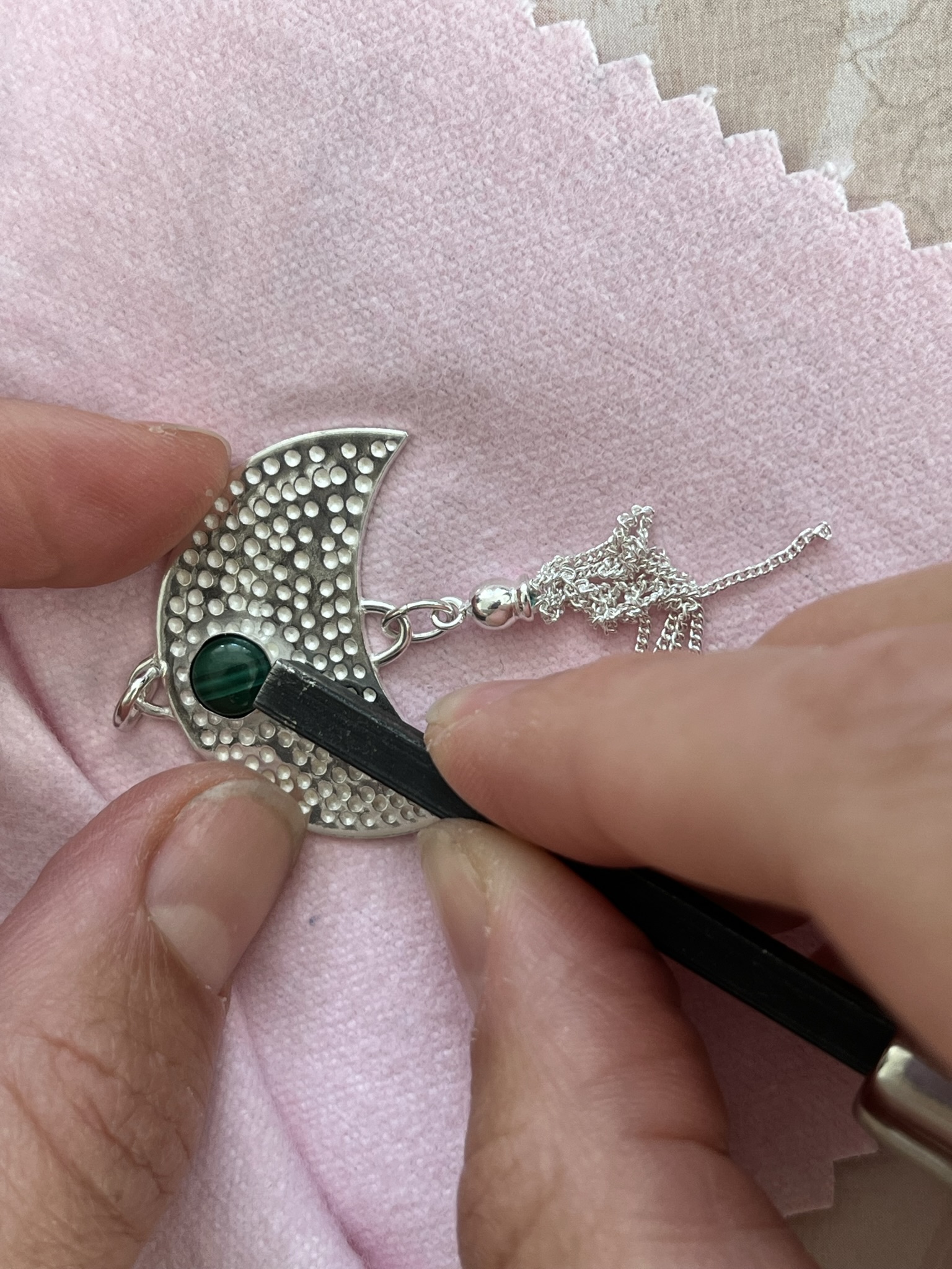 Set the stone in the bezel cup to add the finishing touches to the pendant