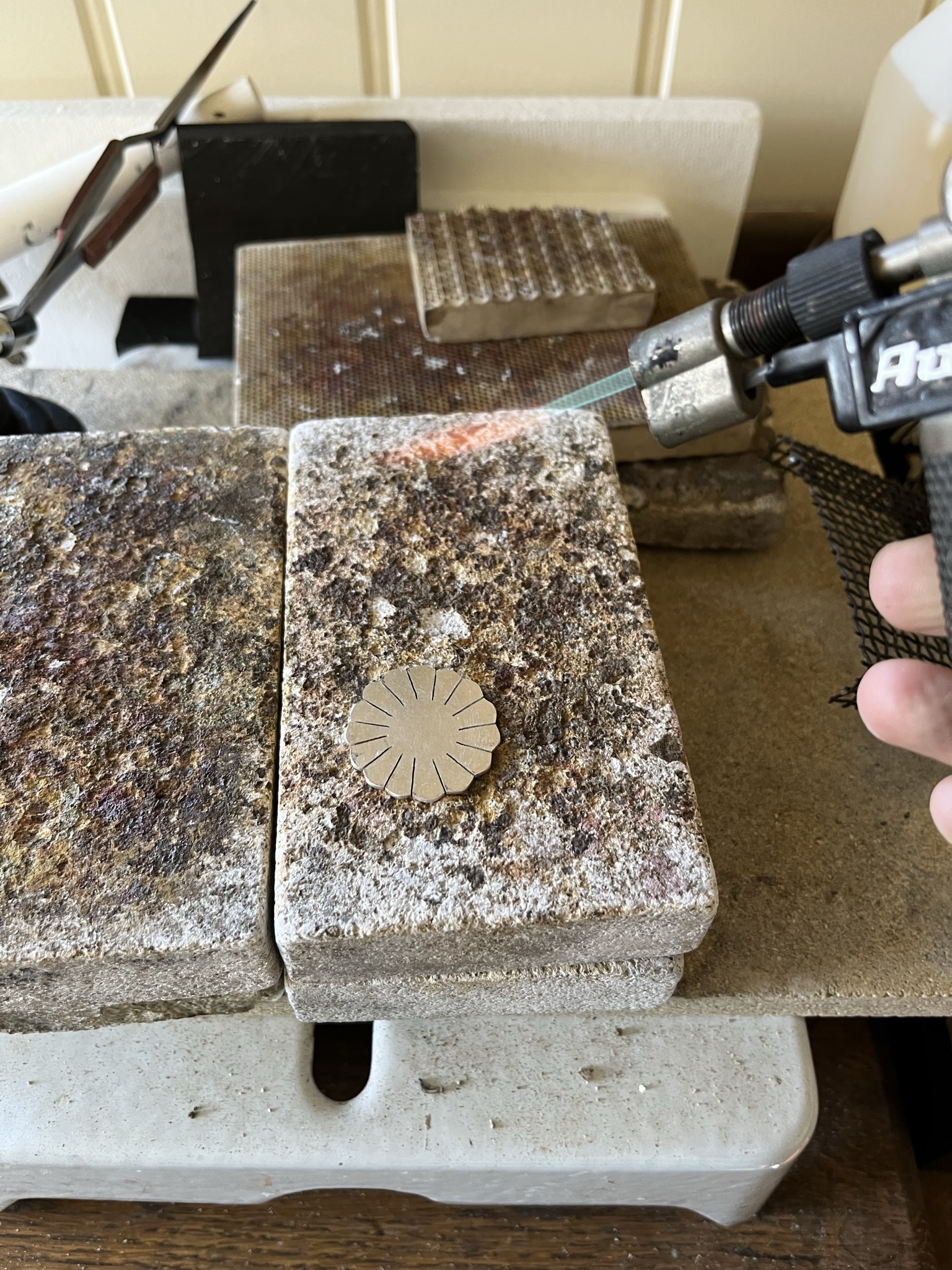 Use a hand blow torch to anneal the silver disc.