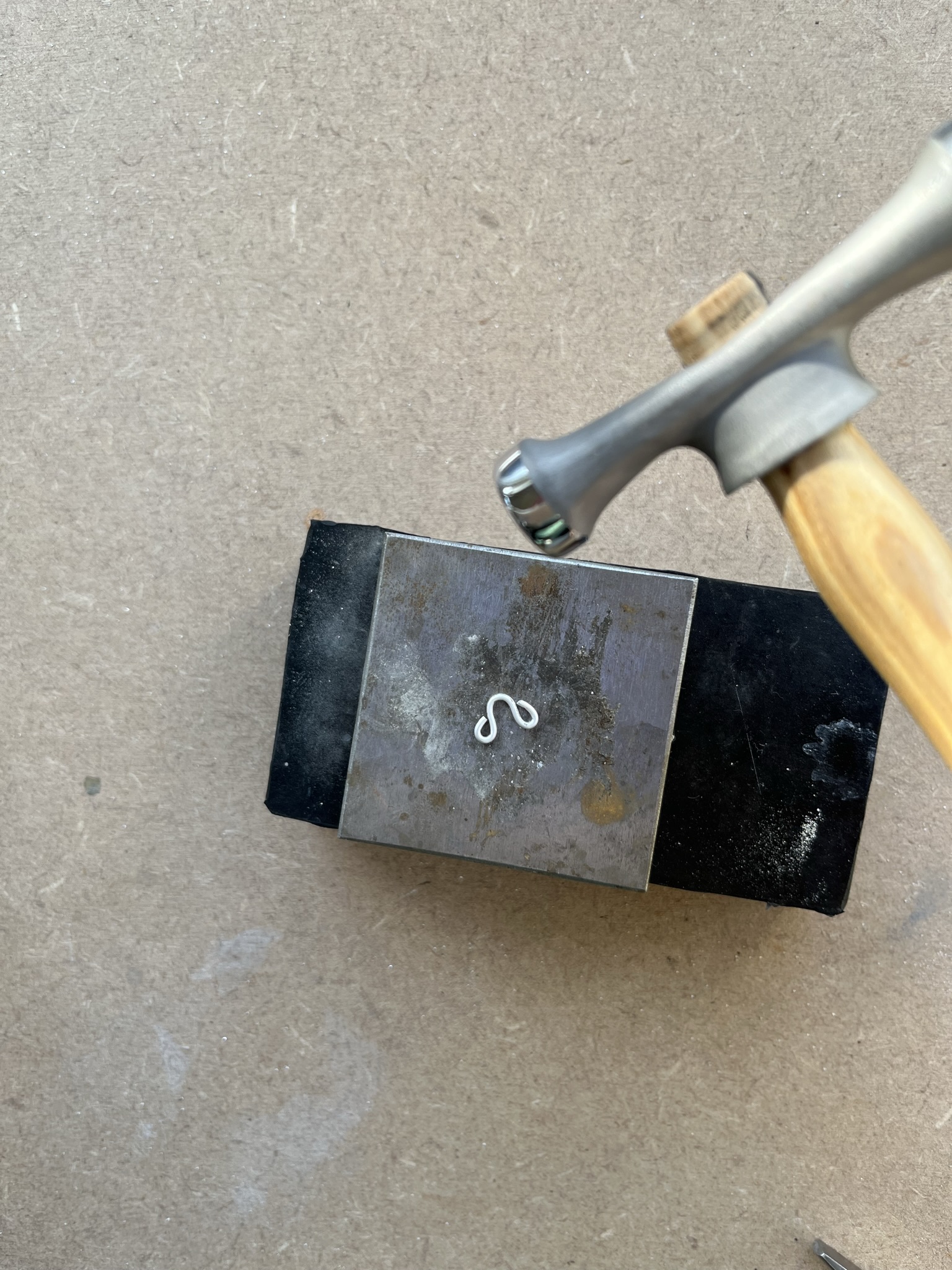 Gently hammer the wire on a steel block.