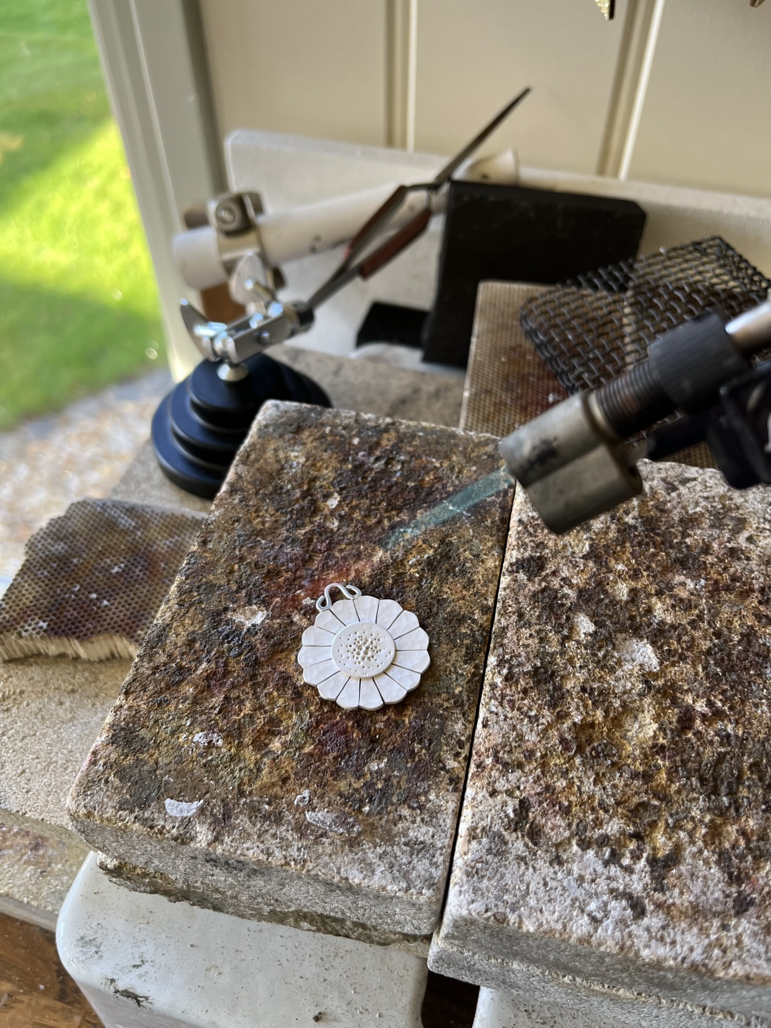 Using a hand blow torch to heat the disc evenly.