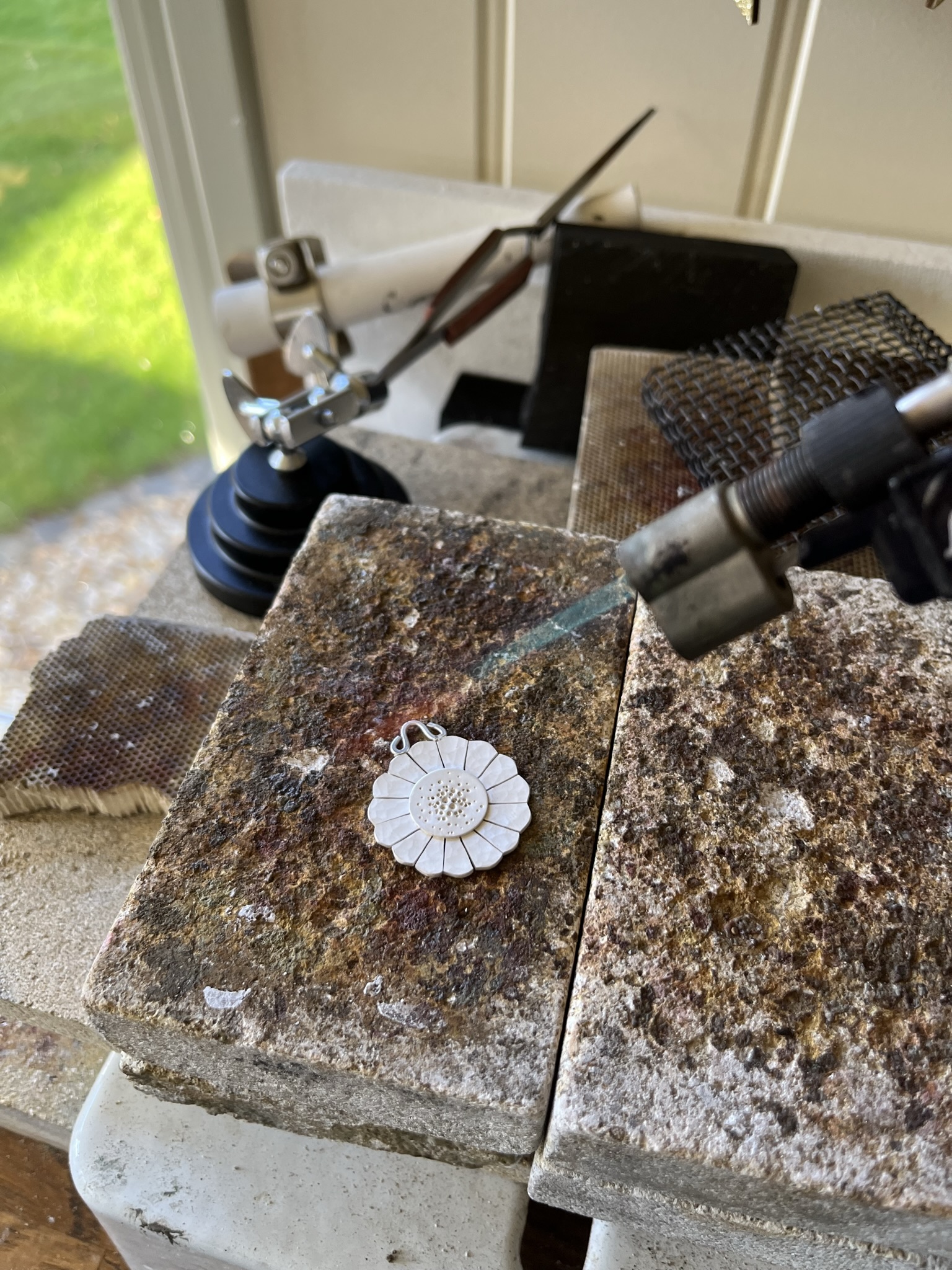 Using a hand blow torch to heat the disc evenly. 