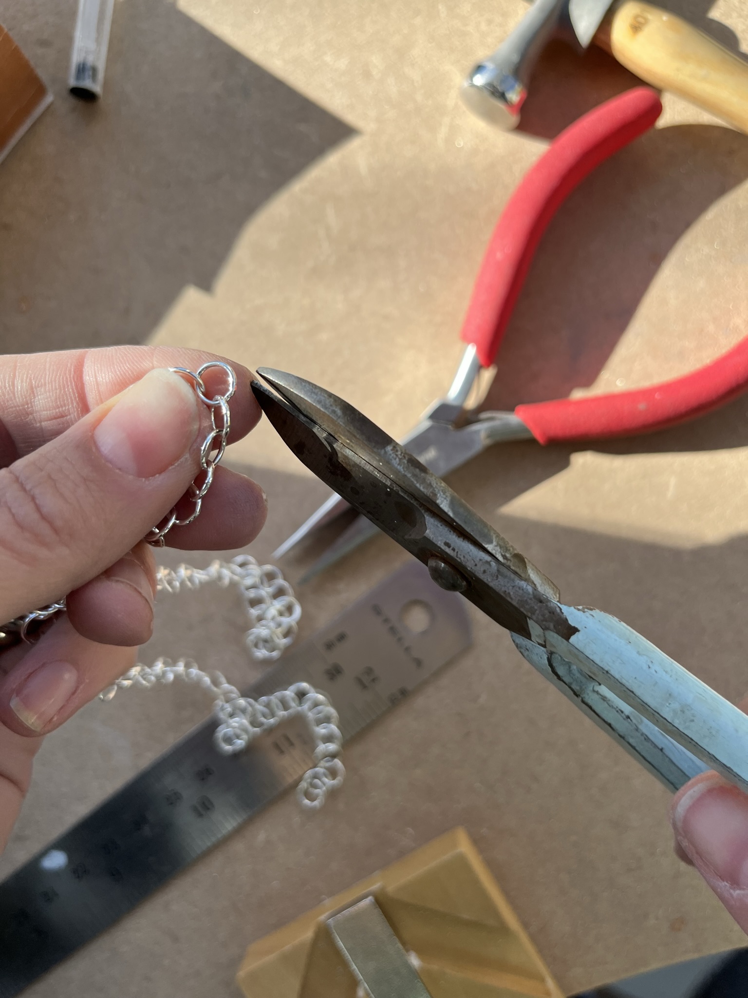 Cut loose chain in half using wire cutters.