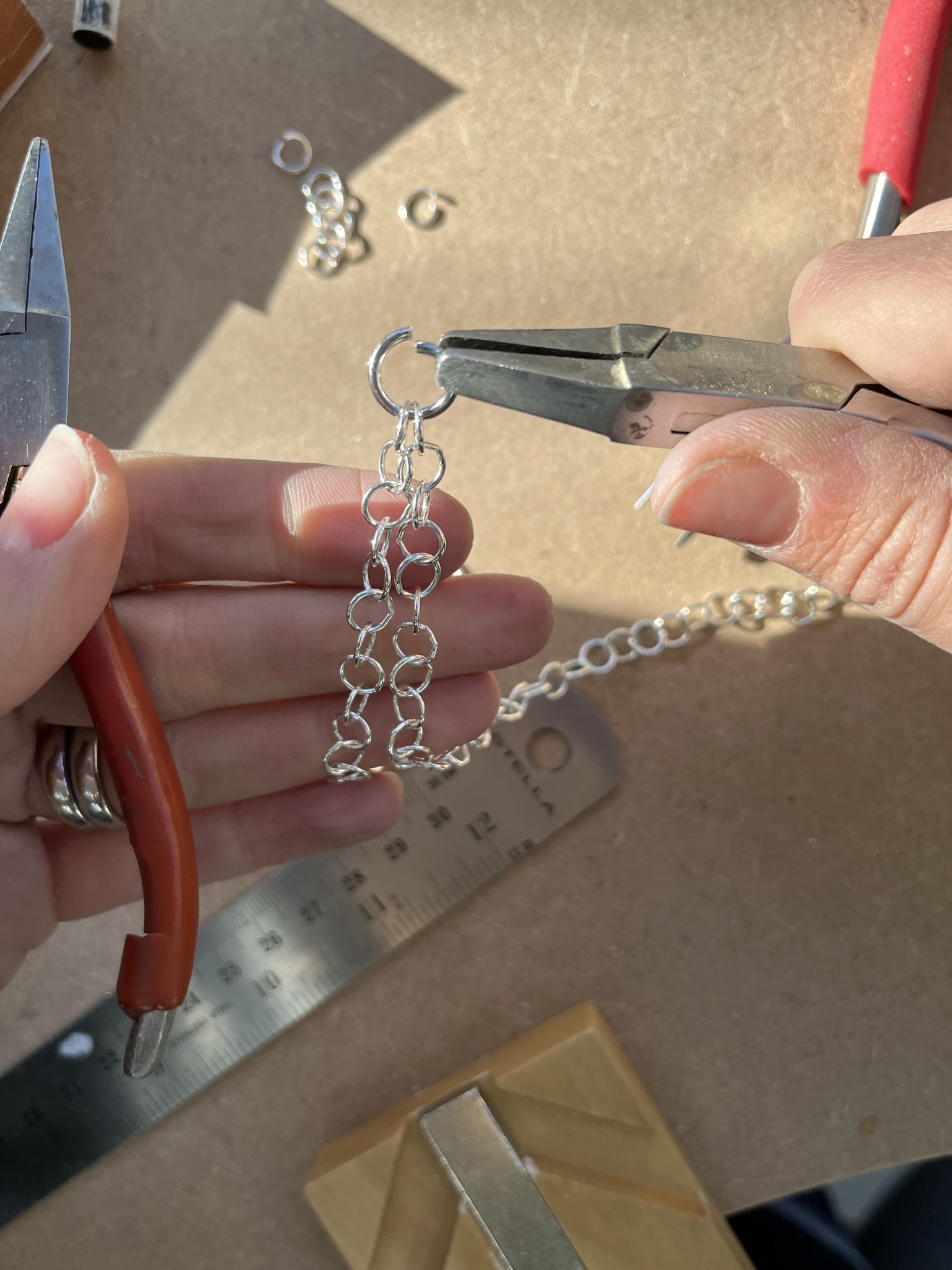Close the jumpring with snipe/chain nose or flat nose pliers.