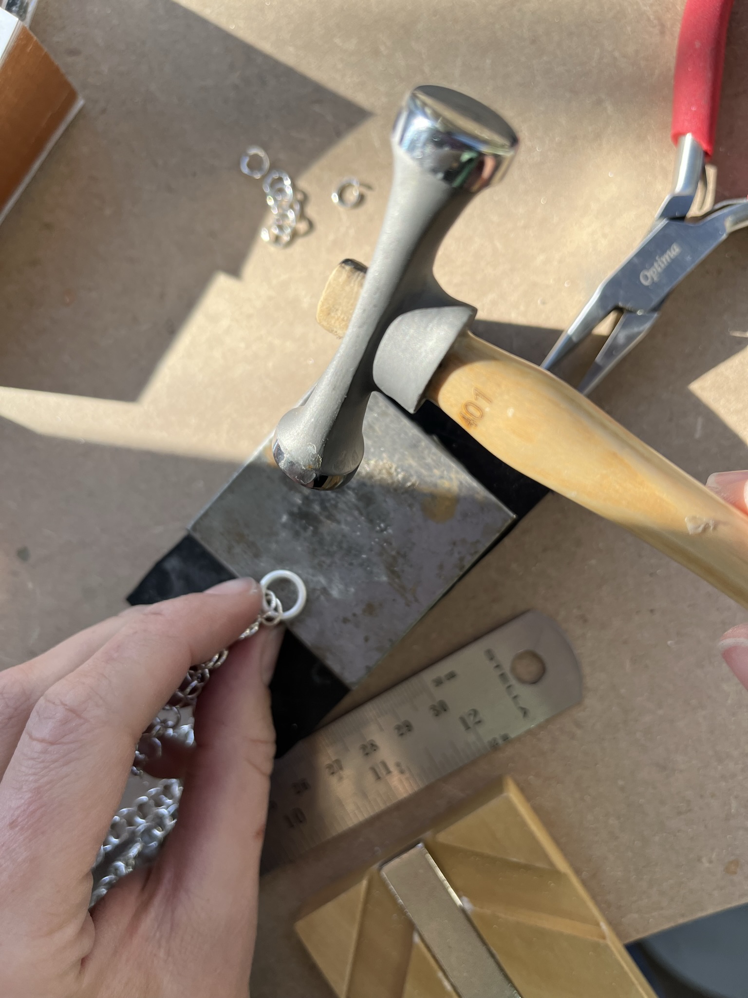 Using a ball hammer to add texture to a jumpring.