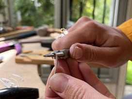 Use round nose pliers to bend the flat end of each wire