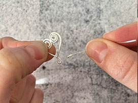 Threading pearl onto swirly heart