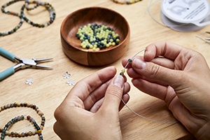 jeweller making beaded jewellery