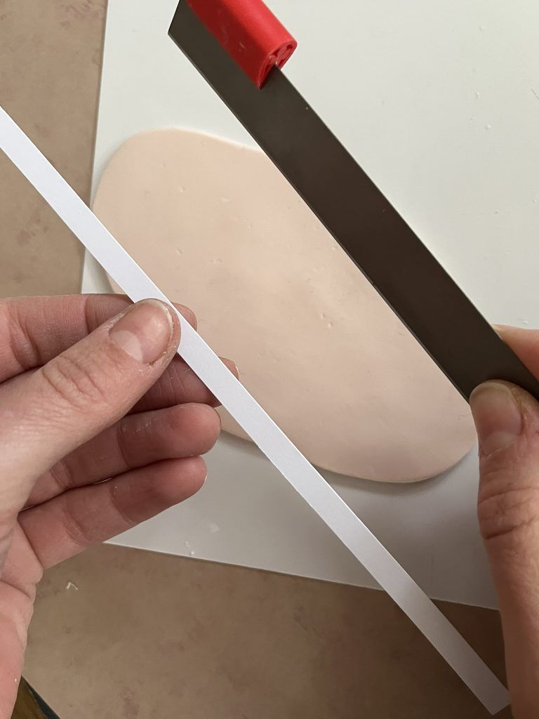 Thin strips using a metal cutter and paper template strip.