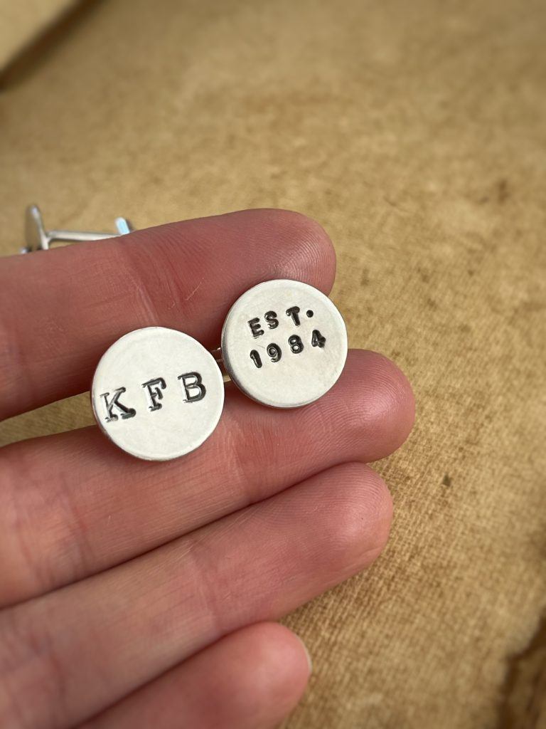 Cufflinks with a cheeky date reference ("Est. 1984") metal stamped onto them.