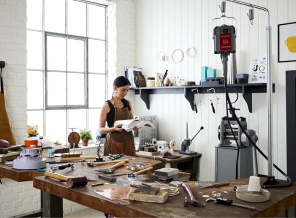 Cooksongold woman in jewellery workshop