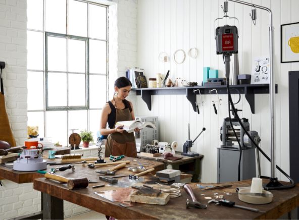 Cooksongold woman in jewellery workshop