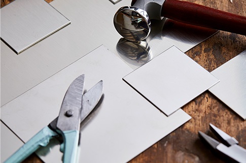 sheet metal and cutting tool on workbench