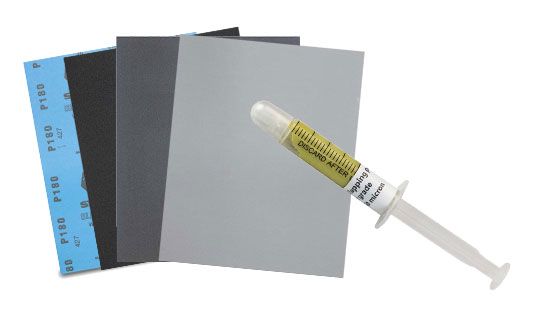 a range of dry polishing paper with a syringe of polishing paste